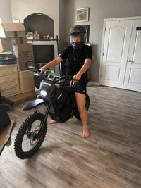 Rider posing indoors with a Terrawulf M7 electric dirt bike